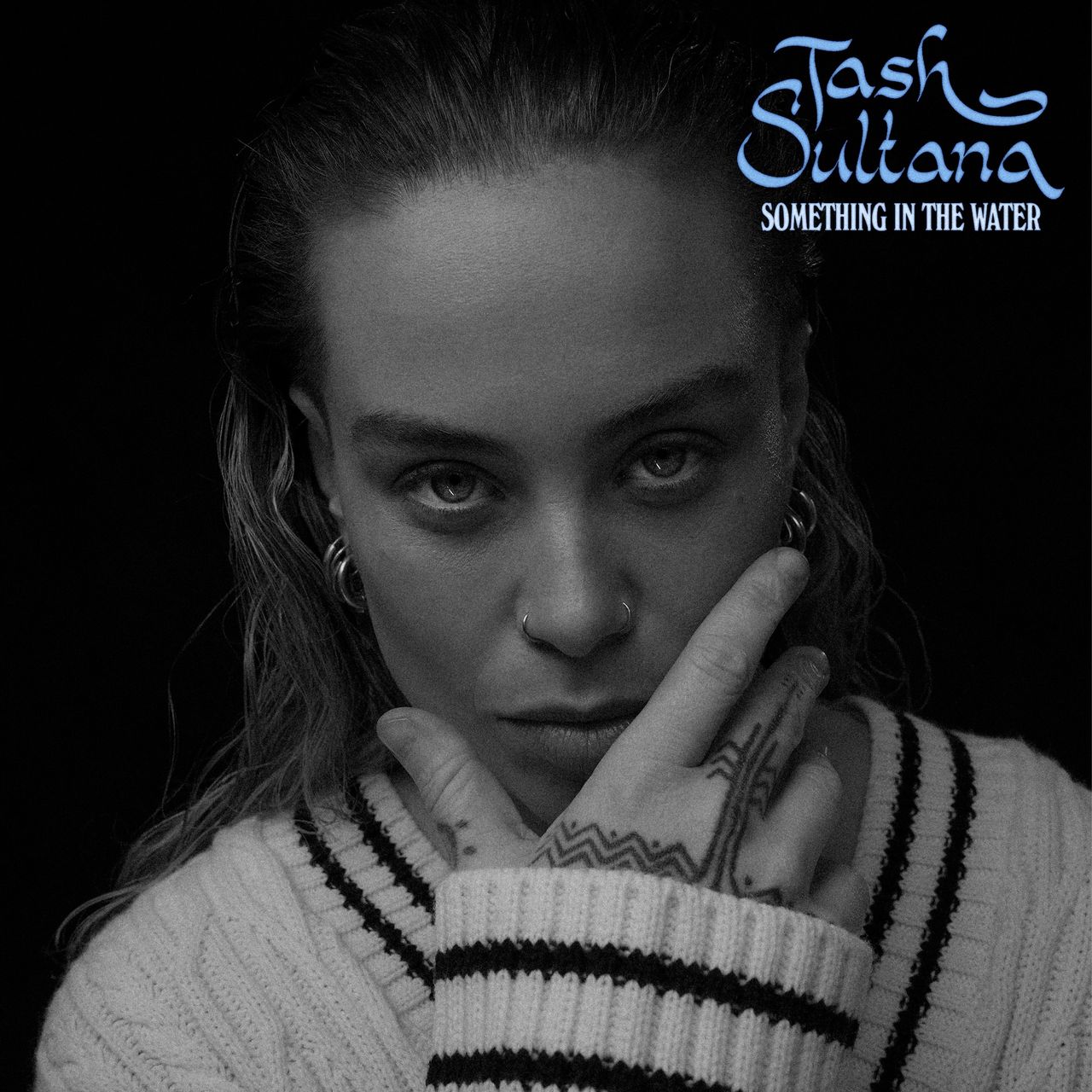 Black and white cover art for Tash Sultana's single Something In The Water, showing a close-up portrait of the artist resting their chin on a hand.